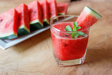 Watermelon drink on wooden background.