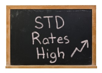 STD rates high written in white chalk on a black chalkboard isolated on white