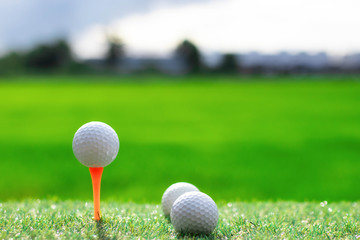 Golf ball on tee on golf course.