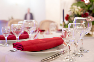 close up table decor for wedding ceremony, table setting, flowers, red and white decor