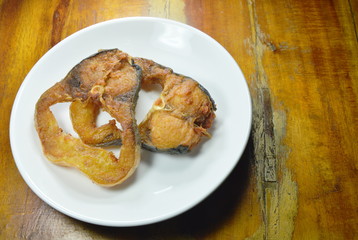 fried salty striped catfish slice on white dish