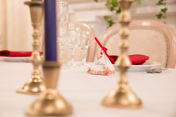 close up table decor for wedding ceremony, table setting, flowers, red and white decor