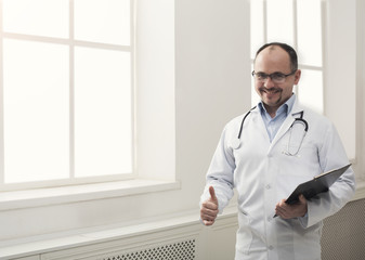 Portrait of doctor in glasses in his office