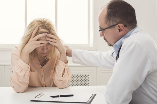 Doctor Consulting Woman In Hospital