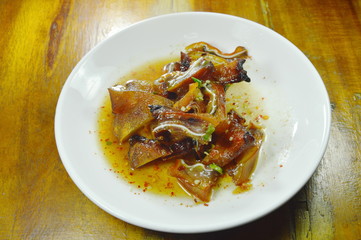 roasted pork ear slice dressing spicy sauce on plate