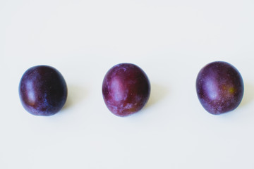 Three plums in a row