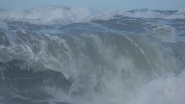 Waves rolling on the beach is a stormy day, winter mediterranean sea. Focene, Lazio, Italy. 4k