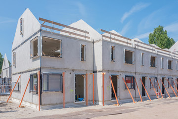 Building site with rows of houses under construction.