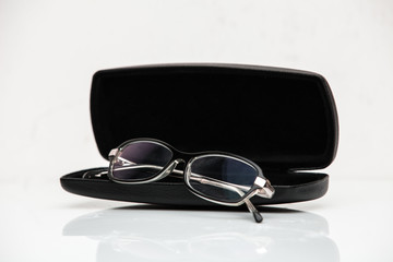 Glasses in a case on a white background