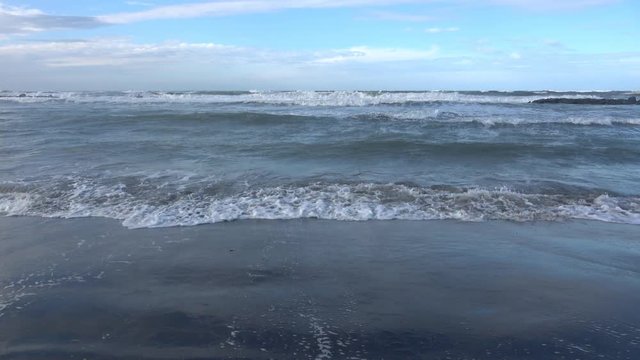 Waves rolling on the beach is a stormy day, winter mediterranean sea. Focene, Lazio, Italy. 4k