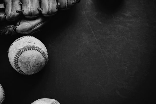 Black and white baseball graphic banner with ball and mitt on grunge background.  Space for sport text or copy.