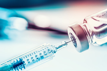 Close-up medical syringe with a vaccine - obrazy, fototapety, plakaty