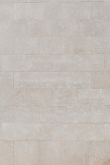 Old sandy marble brick wall in Spain. Texture of marbles bricks