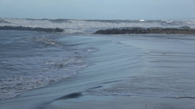 Waves rolling on the beach is a stormy day, winter mediterranean sea. Focene, Lazio, Italy. 4k