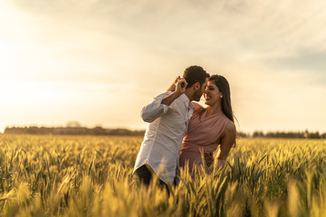 Romantic Couple Exploring at gold wheat field