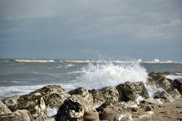 windy day at sea with big waves against rocks