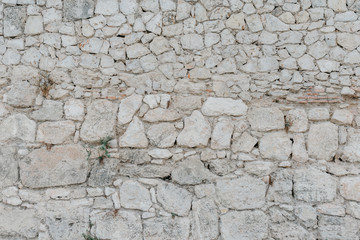 Big gray stone wall. Stone texture. Stones with different shapes