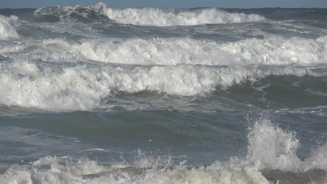 Waves rolling on the beach is a stormy day, winter mediterranean sea. Focene, Lazio, Italy. 4k