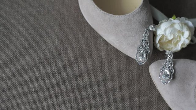 Bridal decorations lie on wedding shoes