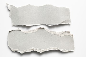 Brown corrugated texture paper torn on white background. rip of cardboard sheet used as a background .