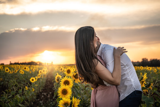 Romantic Couple on a Love Moment in a Sunflower field