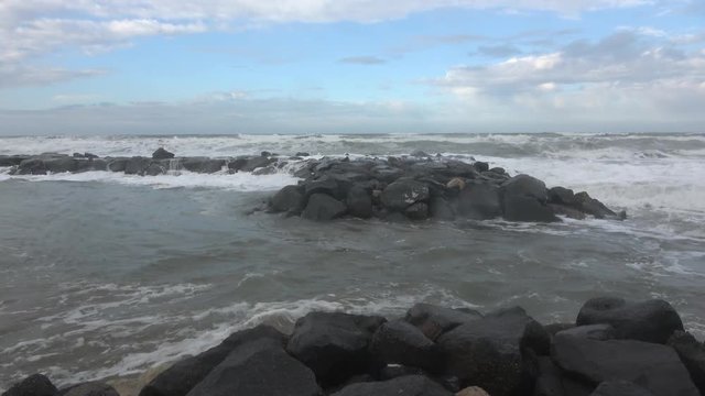 Waves rolling on the beach is a stormy day, winter mediterranean sea. Focene, Lazio, Italy. 4k