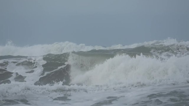 Waves rolling on the beach is a stormy day, winter mediterranean sea. Focene, Lazio, Italy. 4k