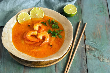Spicy and Soup Curry with Shrimp.Wooden rustic green background.Selective focus