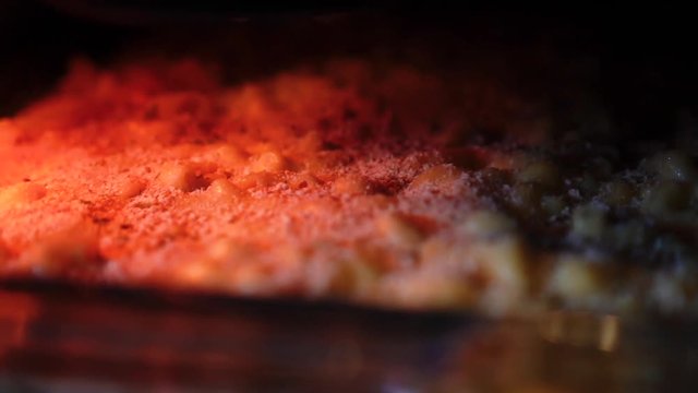 View of macaroni and cheese baking inside an oven