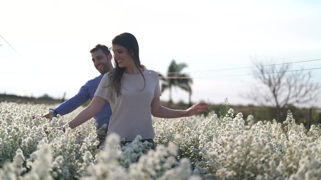 Romantic Couple on a Love Moment in a field of flowers