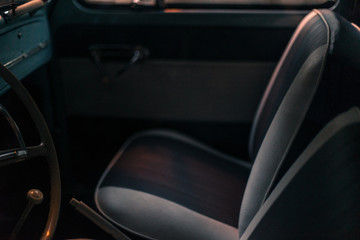 Interior view of vintage chairs in an old classic 'beetle' car