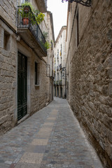 Fototapeta na wymiar Narrow street in Girona Spain