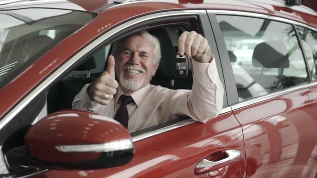 Big purchase. New car. Happy client with the keys of jis new car.
