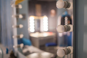 Mirror with light bulbs for make-up with not a sharp second plan