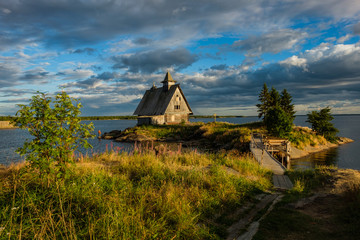 Fototapeta na wymiar Old russian Orthodox wooden church in the village Rabocheostrovsk, Karelia