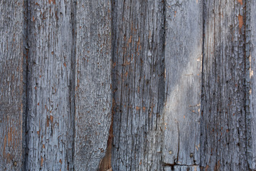 old wooden door with peeling and cracked grey paint