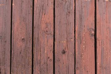 old wooden door with peeling and cracked red paint