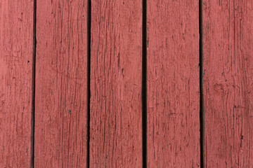 old wooden door with peeling and cracked red paint
