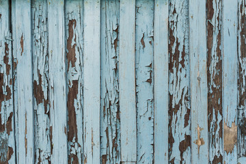 old wooden door with peeling and cracked white paint