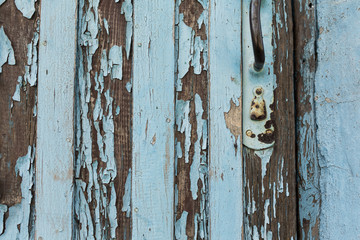 old wooden door with peeling and cracked white paint