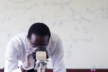 African scientist  Using Microscopes In Laboratory