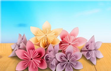 Origami flowers on white background