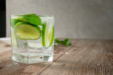glass of iced lime juice on wood table