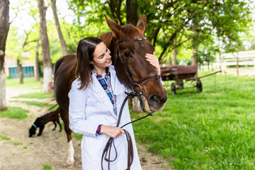 Vet enjoying with a horse outdoors at ranch.