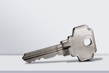 House keys with trinket on wooden background