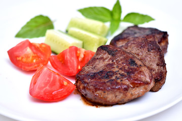 Dish for the restaurant. Fried meat on a plate. Beef with vegetables.