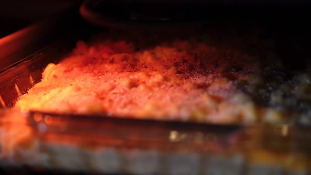 View of macaroni and cheese baking inside an oven