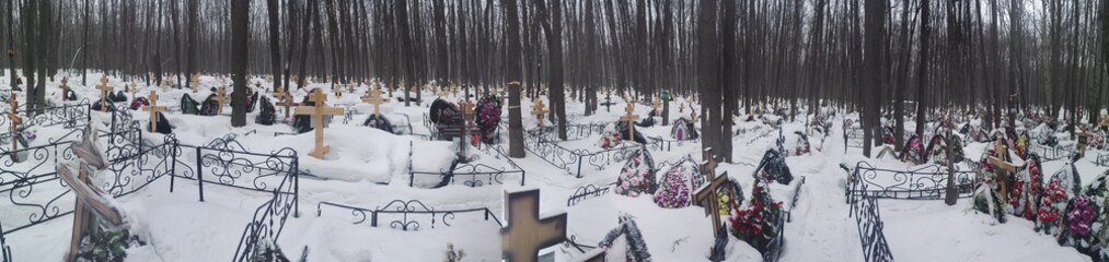 type of cemetery in winter with wooden crosses
