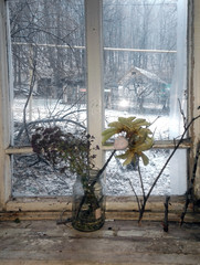 bouquet of dried flowers on window sill in village house