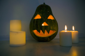 Halloween pumpkin Lamp Jack and candles are burning